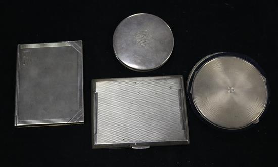 Two silver compacts and two engine turned silver cigarette cases including one modelled as a book.